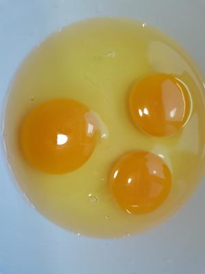 Crack three eggs into a bowl.