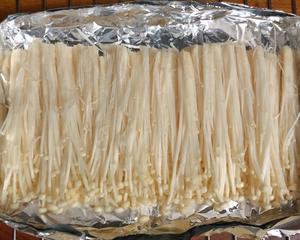 Clean and drain half a handful of enoki mushrooms, then place them on aluminum foil. I used two layers of foil to create a pouch.